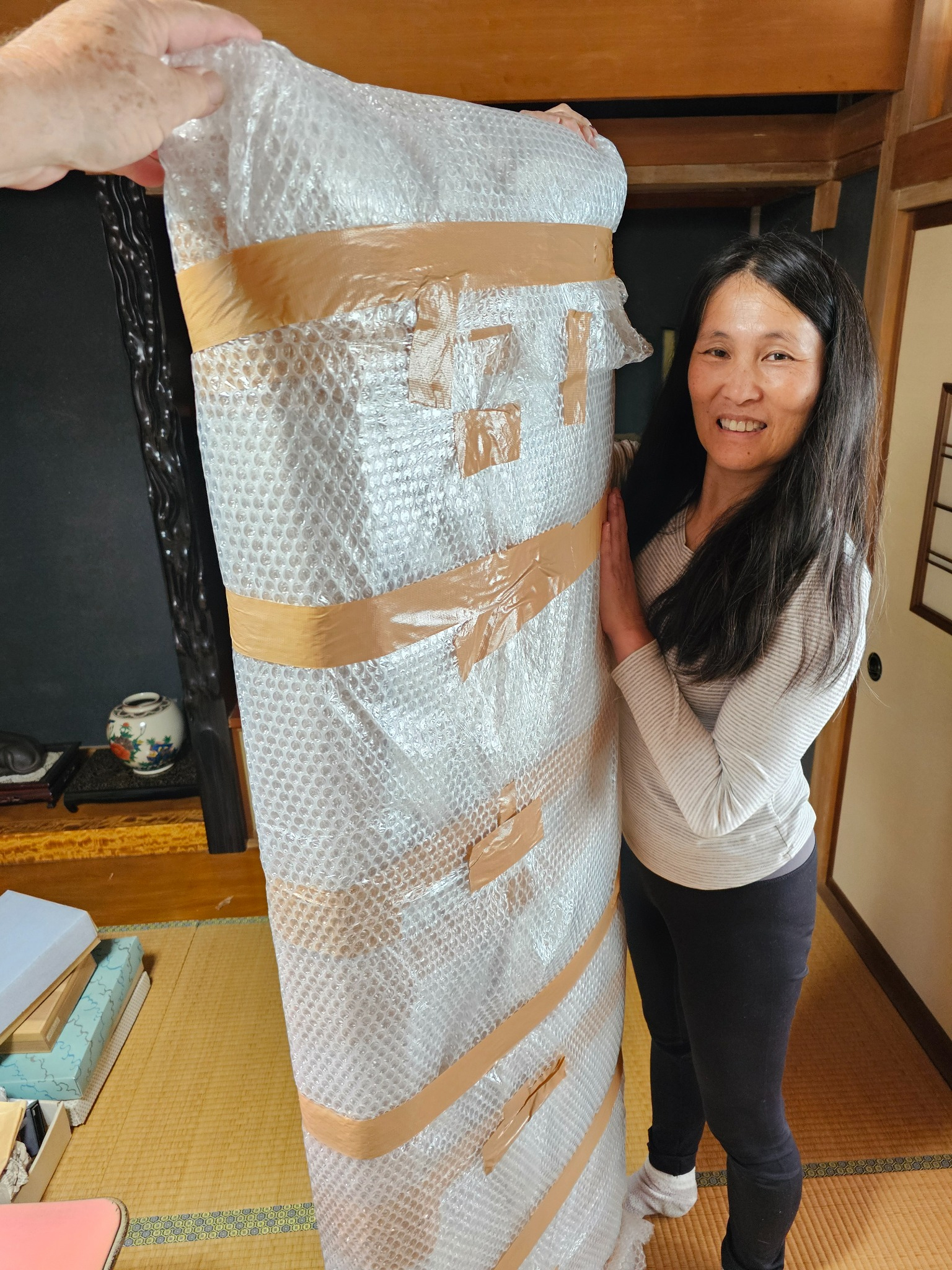 Tomoko with the ranma wrapped for preservation.