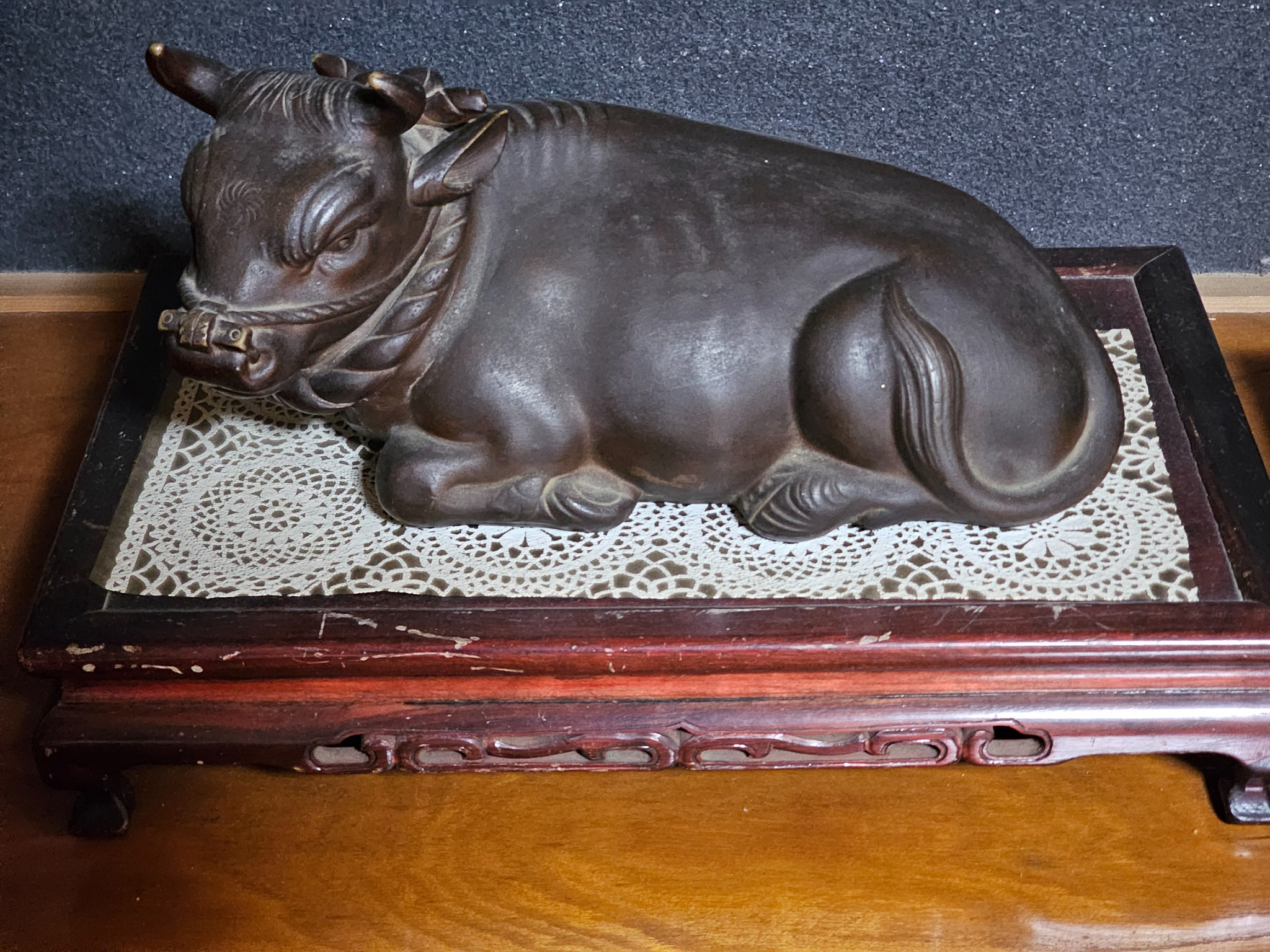 Resting ox figure on stand.