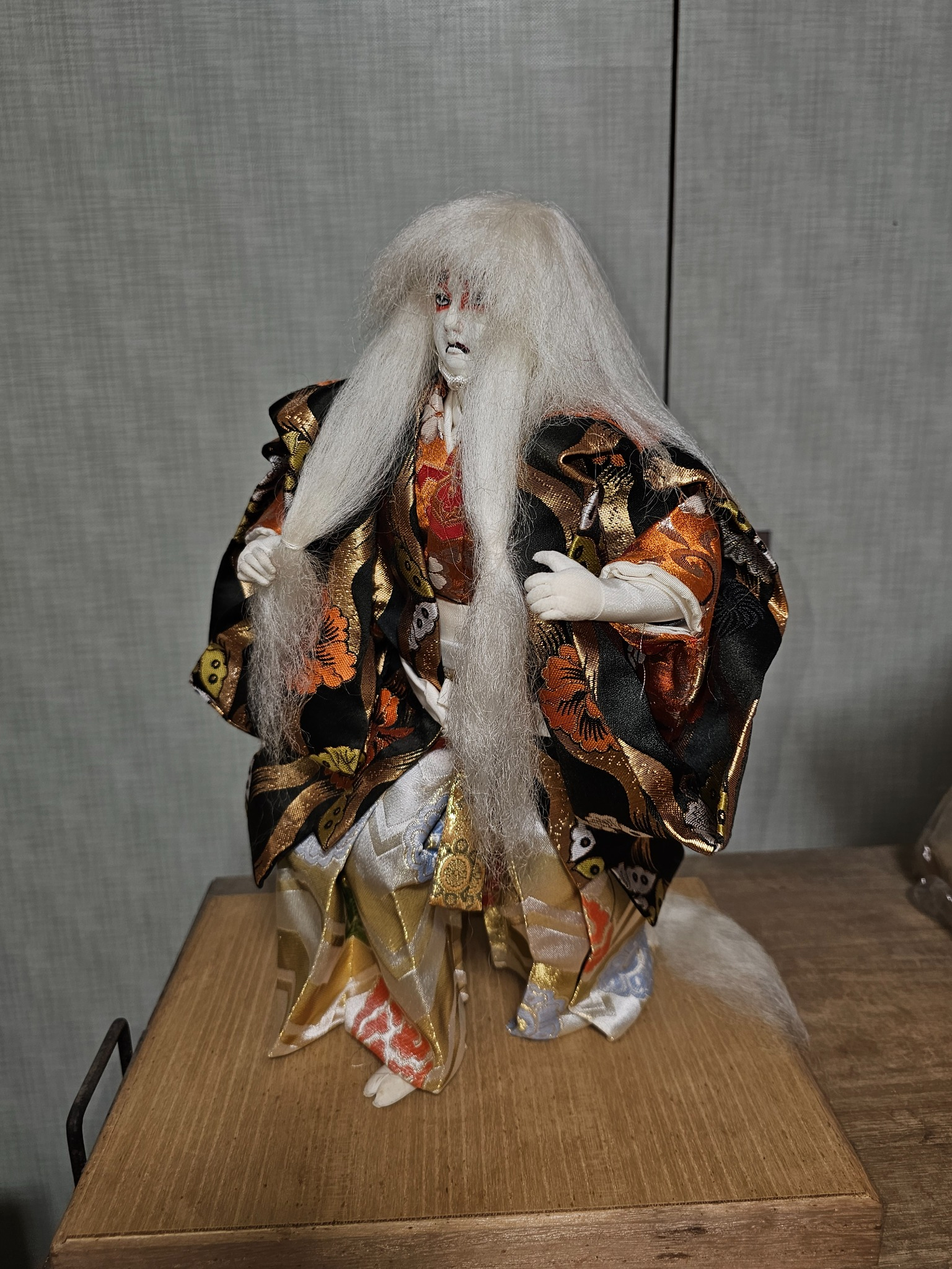 White haired theatrical doll.