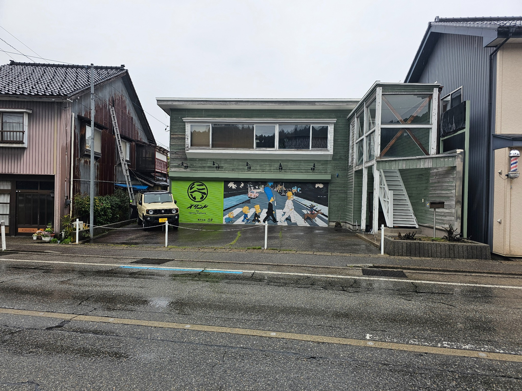 Takkyubin shop in Hanasaki with Beatles shutter mural.