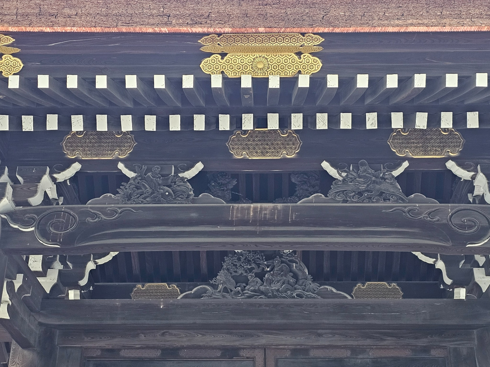 Gold fittings detail on a Kyoto temple gate.
