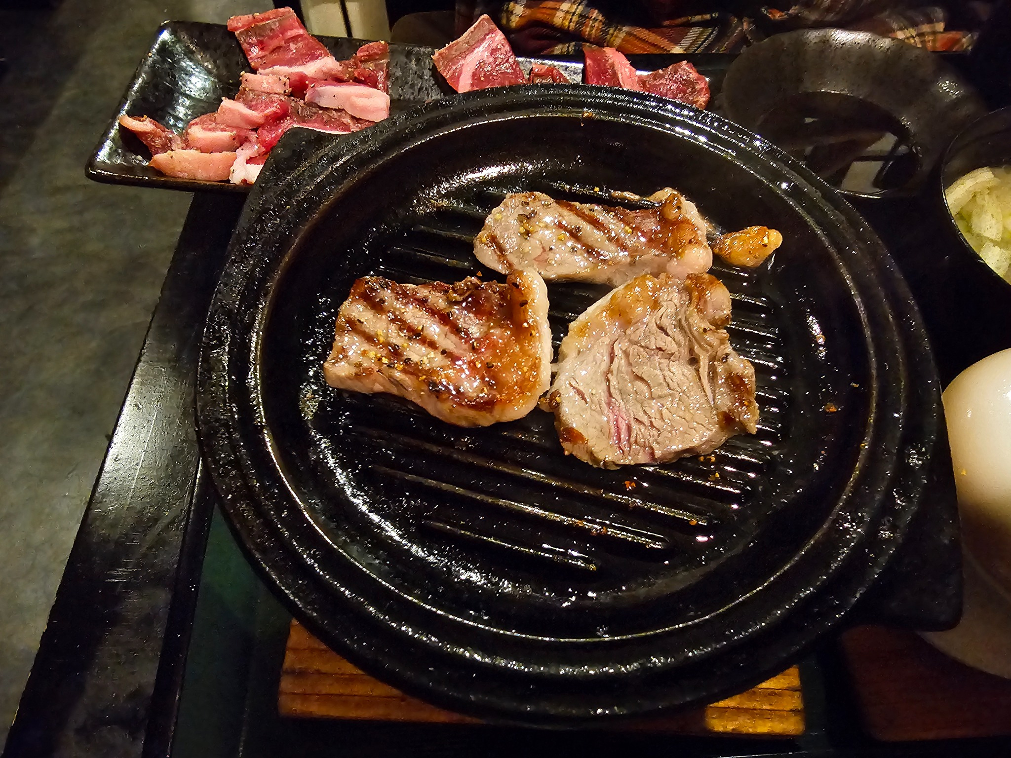 Cooked meat on tabletop grill.