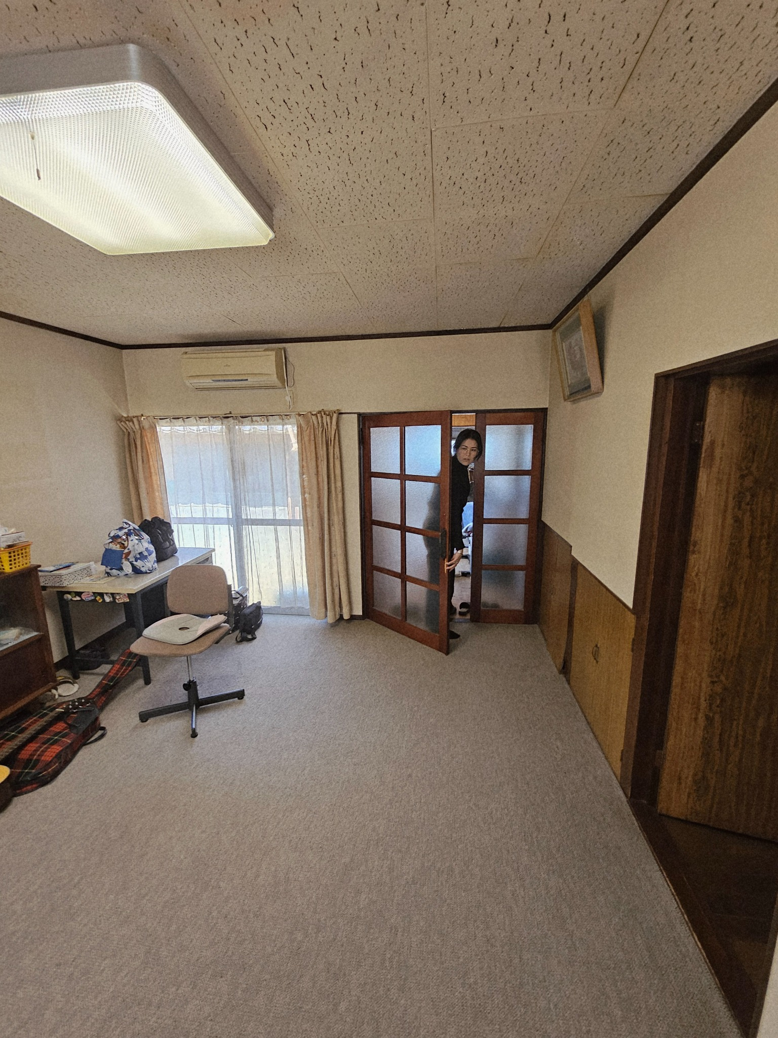 Kitchen area entry door inside the Hanasaki house.