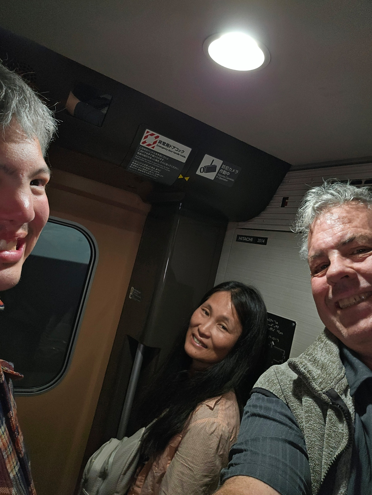 Family selfie in the train vestibule.