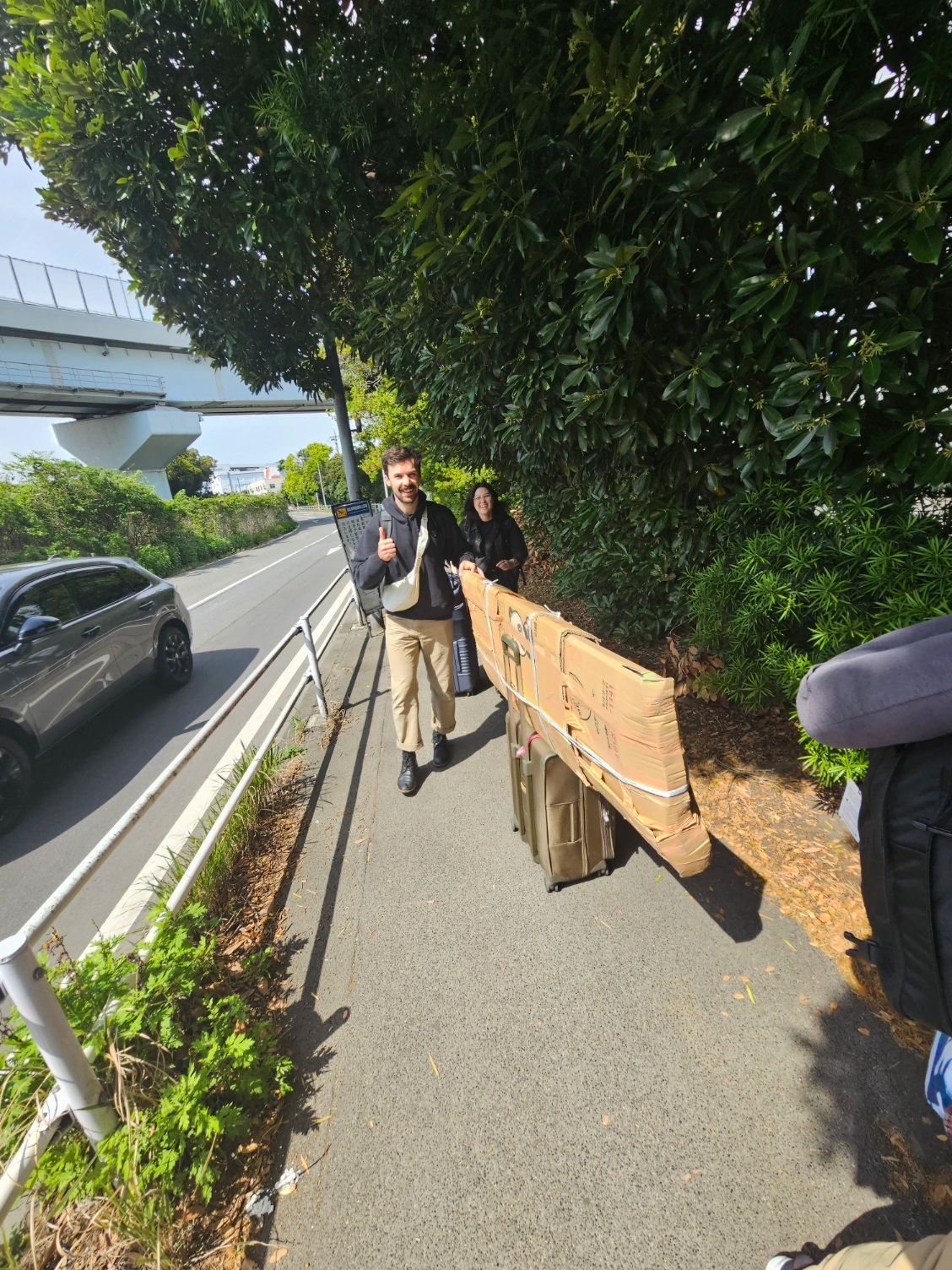 Friends helping carry the long packed ranma.