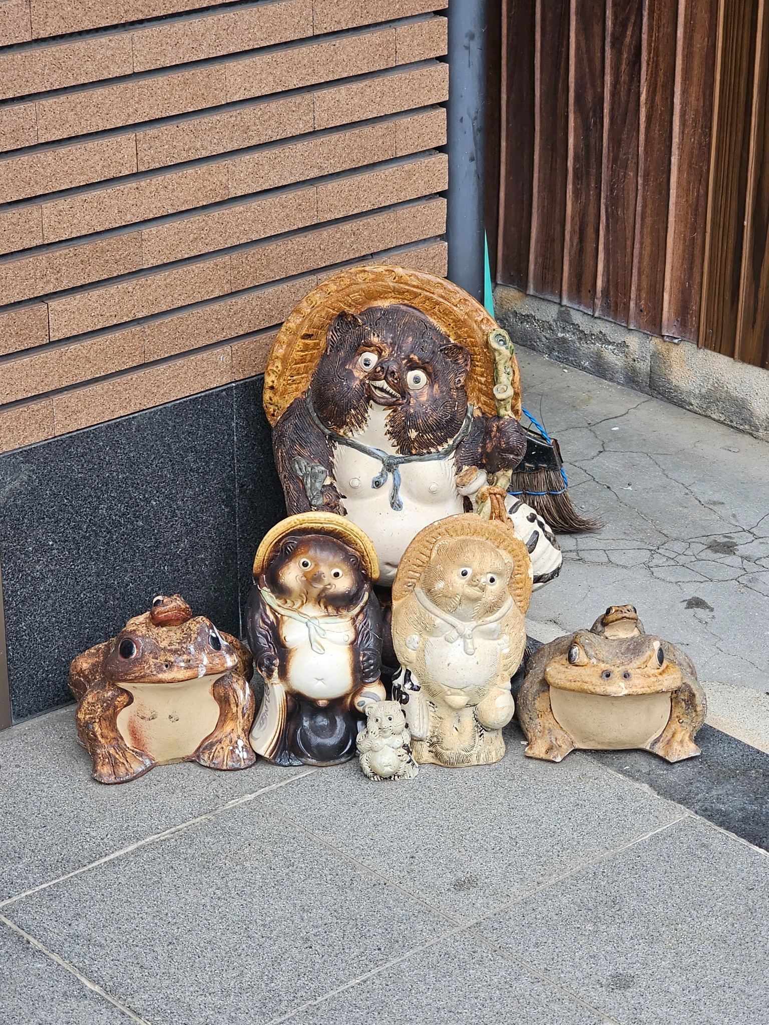Tanuki and frog figures by a door in Kyoto.